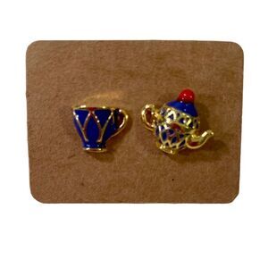 Small “Alice In Wonderland” Style tea pot & cup In Royal blue & gold tones.